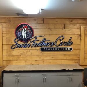 Casino entry with custom signage for Seven Feathers Circle Players Club, showcasing digital printing and large-format graphics.